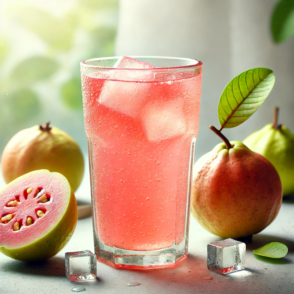 A refreshing glass of homemade guava juice with fresh guavas on the side.